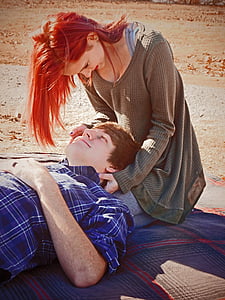 man lying on woman's lap thumbnail