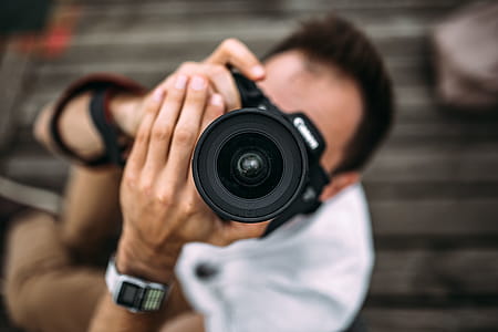 Photographer holding a DSLR camera thumbnail