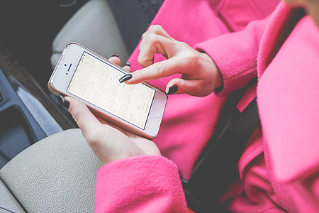 Young Woman Planning in Calendar.app on White iPhone thumbnail