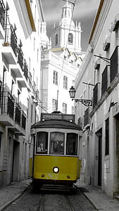 yellow and white train between building structures thumbnail