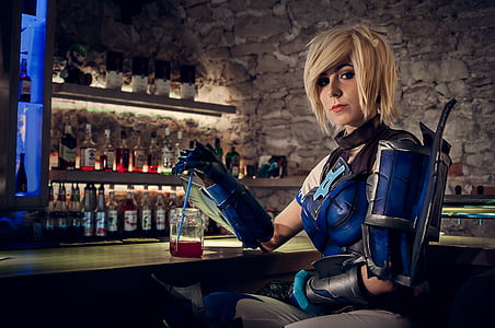 woman in costume sitting on bar table with chair inside room thumbnail
