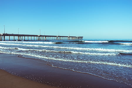 seashore near bridge at daytime thumbnail
