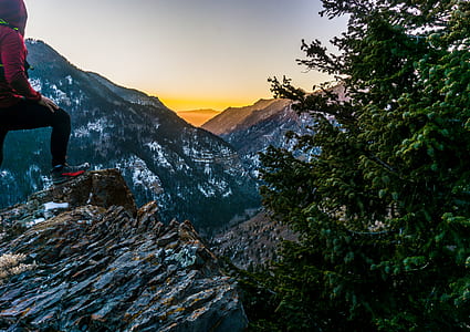 woman standing on cliff during daytime thumbnail