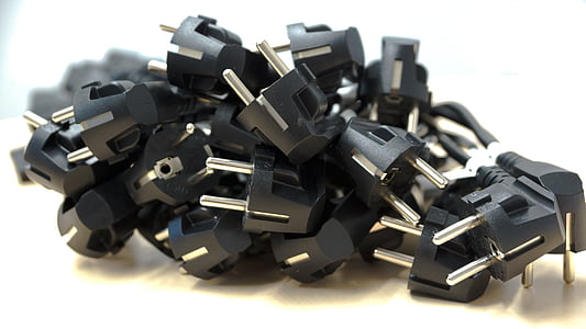 black power plugs piled and placed on beige surface thumbnail