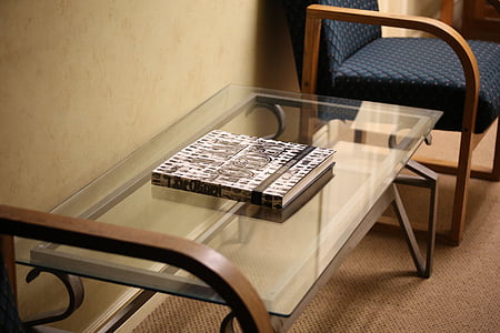 book on glass table in room thumbnail