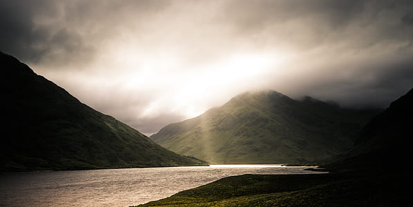 silhouette of mountain beside river thumbnail