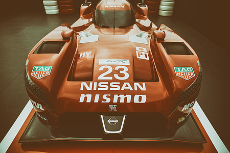 A red sports racing car captured at a race track thumbnail