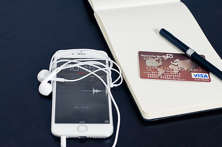 Silver Iphone 6 Beside Red Visa Card thumbnail