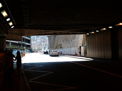 white car driving out road tunnel thumbnail