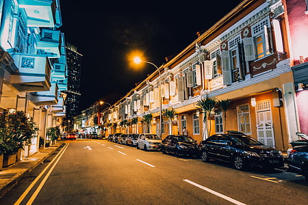 parked inline vehicles beside building thumbnail