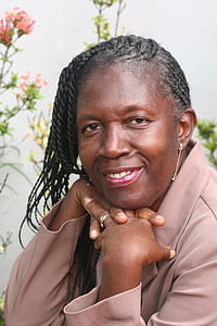 smiling woman in gray collared top thumbnail