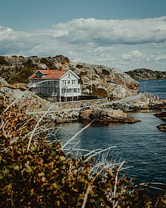 gray 2-storey house beside body of water thumbnail