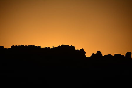 silhouette photography of rock formation during golden hour thumbnail