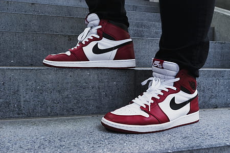 person in black pants with white-and-red Air Jordan 1 basketball shoes thumbnail