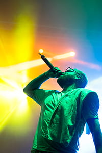 low angle photography of man holding microphone thumbnail