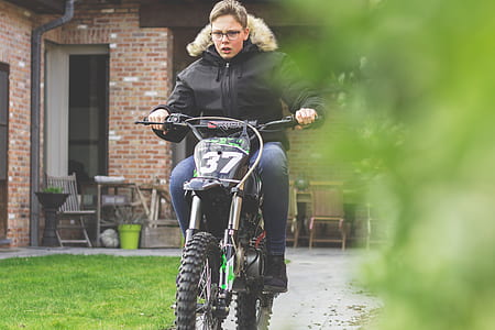man riding dirtbike near house thumbnail