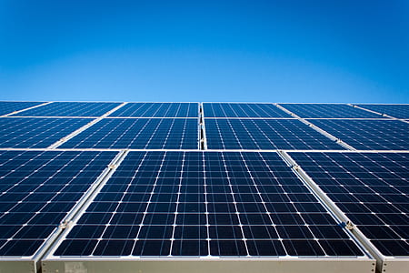 blue solar panels under blue sky during daytime thumbnail