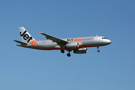 Jetstar Plane Flight Under Blue Sky thumbnail