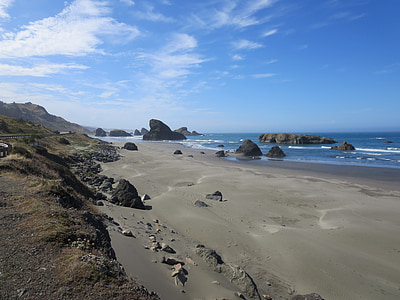 seashore with rock formations under blue sky thumbnail