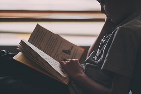 person in gray shirt reading book thumbnail