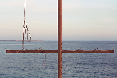 brown metal stand near body of water thumbnail