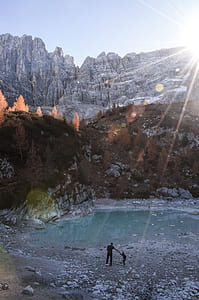 man standing near body of water during daytime thumbnail