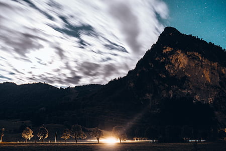 black mountain near road under white clouds thumbnail