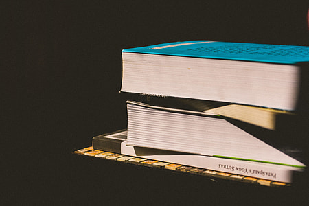 Books stacked up on a black background thumbnail