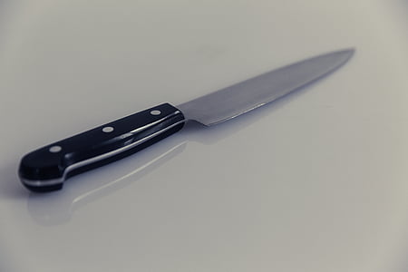 black handle knife on white surface thumbnail