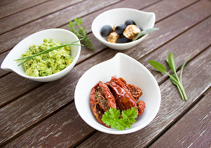 three kinds of dishes in bowls on table thumbnail