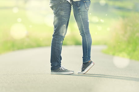 two persons wearing denim jeans and sneakers thumbnail