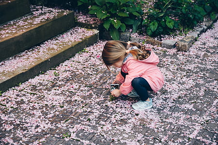 girl on floor near green leaf plant thumbnail