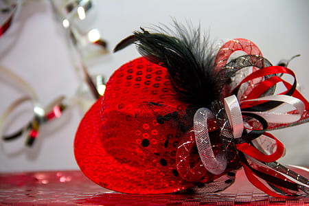 closeup photography of red sequined fascinator hat thumbnail