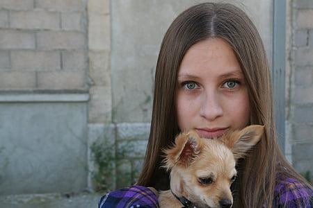 woman carrying short-coated brown dog thumbnail
