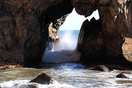 brown rock formations on body of water thumbnail