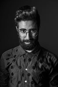 Grayscale Photography of Man Wearing Eyeglasses thumbnail