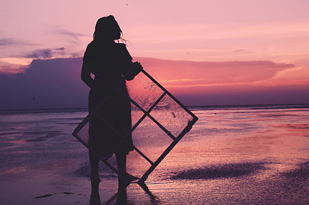 silhouette of woman holding glass panel thumbnail
