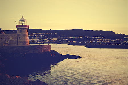 brown lighthouse near body of water thumbnail