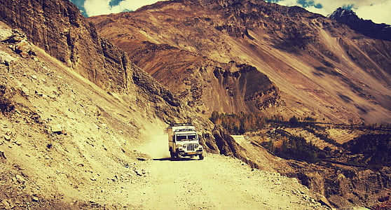 white SUV on dirt road during daytime thumbnail
