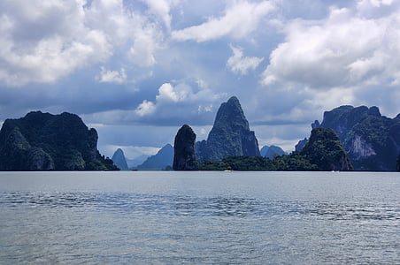 islands with green leaf trees under white clouds at daytime thumbnail