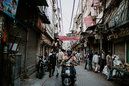 man riding motorcycle near market thumbnail