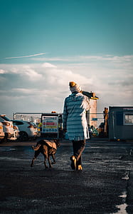 woman walking with dog on focus photo thumbnail