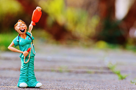 macro photography of doctor holding stethoscope and water bag toy thumbnail