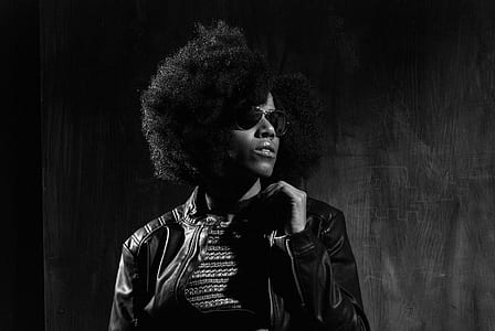 woman in black jacket looking on her left side in grayscale photography thumbnail