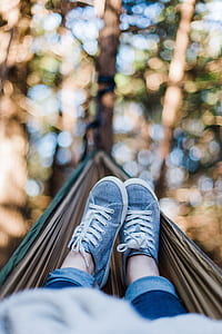 selective focus photography of person on hammock thumbnail