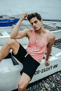 man sitting on white boat thumbnail