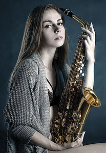 woman holding brass saxophone photography thumbnail