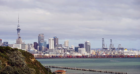 landscape photography of buildings near body of water during daytime thumbnail