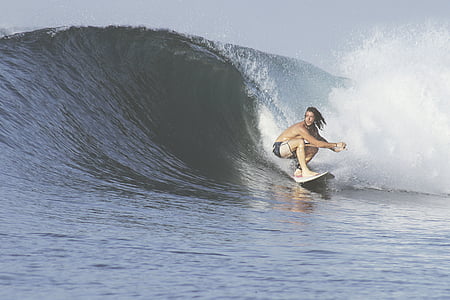 man on white surfboard on wave thumbnail