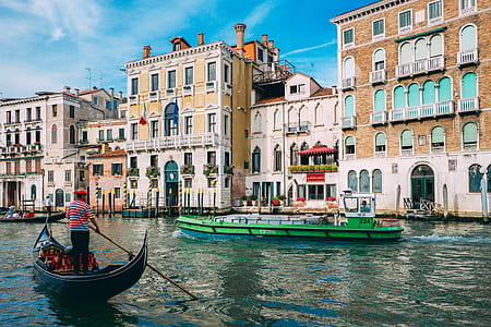 man on gondola boat rowing on Venice Grand Canal during daytime thumbnail